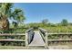 Wooden dock with railings overlooking serene water surrounded by lush greenery and palm trees at 610 Alligator Dr, Venice, FL 34293