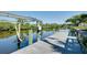 Dock with boat lift and ladder provides convenient water access for recreation at 610 Alligator Dr, Venice, FL 34293