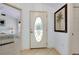 Bright entryway with decorative glass door and views of the bedroom at 610 Alligator Dr, Venice, FL 34293
