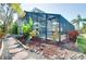 Manicured backyard with a screened-in pool, unique landscaping and stepping stone pavers at 610 Alligator Dr, Venice, FL 34293