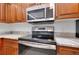 Modern kitchen features stainless steel appliances, granite countertops, and wood cabinets for cooking convenience at 610 Alligator Dr, Venice, FL 34293