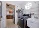 Bright laundry area with modern appliances, a utility sink, and storage options for efficient organization at 610 Alligator Dr, Venice, FL 34293
