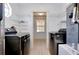 Functional laundry room with modern appliances, wire shelving, and ample space for laundry tasks at 610 Alligator Dr, Venice, FL 34293