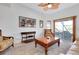 Cozy living room with vaulted ceilings, a ceiling fan, and access to the screened-in patio at 610 Alligator Dr, Venice, FL 34293