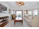 Bright and airy living room with a vaulted ceiling, fan, and access to an outdoor patio for relaxation at 610 Alligator Dr, Venice, FL 34293