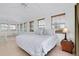 Bright main bedroom with neutral decor, tile flooring, and multiple windows offering plenty of natural light at 610 Alligator Dr, Venice, FL 34293