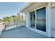 Comfortable outdoor deck with sliding glass doors to the interior and views of tropical landscaping at 610 Alligator Dr, Venice, FL 34293