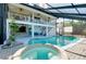 Enjoy a screened-in pool and spa with white trim and a two-story deck perfect for entertaining at 610 Alligator Dr, Venice, FL 34293