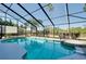 Inviting pool area featuring a sparkling pool and lush landscaping, creating a private oasis for relaxation and enjoyment at 610 Alligator Dr, Venice, FL 34293