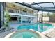 Enjoy a screened-in pool and spa with white trim and a two-story deck perfect for entertaining at 610 Alligator Dr, Venice, FL 34293