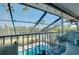 Relaxing screened-in lanai with seating overlooking the pool, offering a comfortable outdoor experience at 610 Alligator Dr, Venice, FL 34293