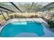 Private swimming pool with attached spa and screened enclosure for a clean and inviting outdoor space at 610 Alligator Dr, Venice, FL 34293