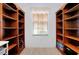 Spacious walk-in closet with custom built-in shelving, a window, and a clean design for optimal storage at 610 Alligator Dr, Venice, FL 34293