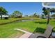 Scenic backyard featuring a tranquil pond and lush green space, perfect for outdoor relaxation at 611 Paget Dr, Venice, FL 34293
