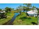 Scenic backyard with a canal view and lush landscaping, perfect for outdoor relaxation at 611 Paget Dr, Venice, FL 34293