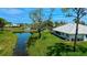 Scenic backyard with a canal view and lush landscaping, perfect for outdoor relaxation at 611 Paget Dr, Venice, FL 34293