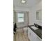 Well-lit bathroom featuring a granite countertop vanity, modern fixtures, and shower with updated tile at 611 Paget Dr, Venice, FL 34293