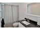 Well-lit bathroom featuring a granite countertop vanity, modern fixtures, and shower with updated tile at 611 Paget Dr, Venice, FL 34293
