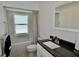 Well-lit bathroom featuring a granite countertop vanity, modern fixtures, and shower with updated tile at 611 Paget Dr, Venice, FL 34293