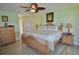 Inviting bedroom with a wooden bed frame, tropical accents, and natural light at 611 Paget Dr, Venice, FL 34293