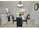 Elegant dining room with vaulted ceilings and a glass table under modern lighting fixture at 611 Paget Dr, Venice, FL 34293