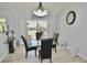 Elegant dining room with vaulted ceilings and a glass table under modern lighting fixture at 611 Paget Dr, Venice, FL 34293