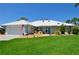 Charming single-story home boasting a well-manicured lawn, clean white tiled roof, and a welcoming two-car garage at 611 Paget Dr, Venice, FL 34293