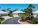 Charming home with a well-manicured lawn, driveway, and beautiful landscaping at 611 Paget Dr, Venice, FL 34293