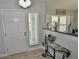 Inviting foyer with wood-look flooring, stylish decor, and a front door with sidelight at 611 Paget Dr, Venice, FL 34293