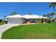 Charming home with a well-manicured lawn, a white exterior, and a welcoming entrance at 611 Paget Dr, Venice, FL 34293
