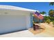 Charming home featuring a manicured front yard, an American flag, and a clean two-car garage at 611 Paget Dr, Venice, FL 34293