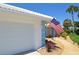 Close up of a charming home with an American flag and a beautifully landscaped front yard at 611 Paget Dr, Venice, FL 34293