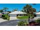 Charming single-story home with a well-manicured lawn, driveway, and lovely landscaping at 611 Paget Dr, Venice, FL 34293