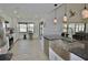 Open concept kitchen with stainless appliances, white cabinetry, granite countertops, and a large island at 611 Paget Dr, Venice, FL 34293