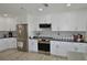 Updated kitchen featuring stainless steel appliances, granite countertops, and custom white cabinetry at 611 Paget Dr, Venice, FL 34293