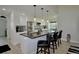 Modern kitchen featuring a granite island with seating, stainless steel appliances, and elegant pendant lighting at 611 Paget Dr, Venice, FL 34293