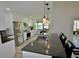 Spacious kitchen featuring granite counters, stainless appliances, white cabinets, and a modern pendant light at 611 Paget Dr, Venice, FL 34293