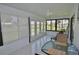 Enclosed lanai with tile flooring and views of the serene backyard and pond at 611 Paget Dr, Venice, FL 34293