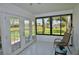 Enclosed lanai with tile flooring and views of the serene backyard and pond at 611 Paget Dr, Venice, FL 34293