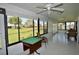 Enclosed lanai with tile flooring and views of the serene backyard and pond at 611 Paget Dr, Venice, FL 34293