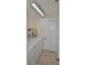 Functional laundry room featuring a washer, dryer, storage shelves, and wood-look flooring at 611 Paget Dr, Venice, FL 34293