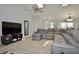Spacious living room with vaulted ceilings, a large sectional sofa, and a modern entertainment center at 611 Paget Dr, Venice, FL 34293