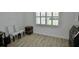 Bright room featuring two chairs, accent tables, and wood look floors under a window at 611 Paget Dr, Venice, FL 34293