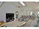 Spacious living room with modern ceiling fan, vaulted ceilings, and a large leather sectional at 611 Paget Dr, Venice, FL 34293