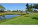 Scenic pond view with lush landscaping, offering a tranquil and picturesque setting at 611 Paget Dr, Venice, FL 34293