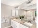 Bathroom with dual sinks, granite countertops, and a seamless glass shower at 6126 Spinnaker Blvd, Englewood, FL 34224