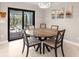 Dining room with a wooden table, chairs and sliding glass doors to a screened patio at 6126 Spinnaker Blvd, Englewood, FL 34224