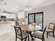Dining area adjacent to the kitchen with sliding glass doors to the outdoor patio at 6126 Spinnaker Blvd, Englewood, FL 34224
