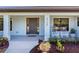 Inviting front porch with rocking chairs and landscaping framing the front entry at 6126 Spinnaker Blvd, Englewood, FL 34224