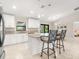 Open-concept kitchen features white cabinetry, stainless appliances, and granite countertops at 6126 Spinnaker Blvd, Englewood, FL 34224